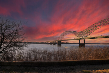 a majestic shot of the Memphis & Arkansas Bridge over the vast flowing waters of the Mississippi...