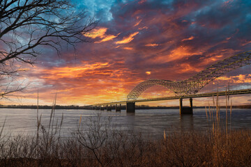 a breathtaking shot of the Memphis-Arkansas Bridge over the flowing waters of the Mississippi river...