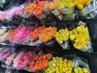 Bouquets of multi-colored roses arranged in a row for Valentine's Day and important festivals