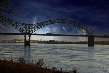 a stunning shot of the Memphis-Arkansas Bridge over the vast flowing waters of the Mississippi...