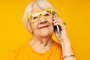 smiling elderly woman fun talking on the phone isolated background