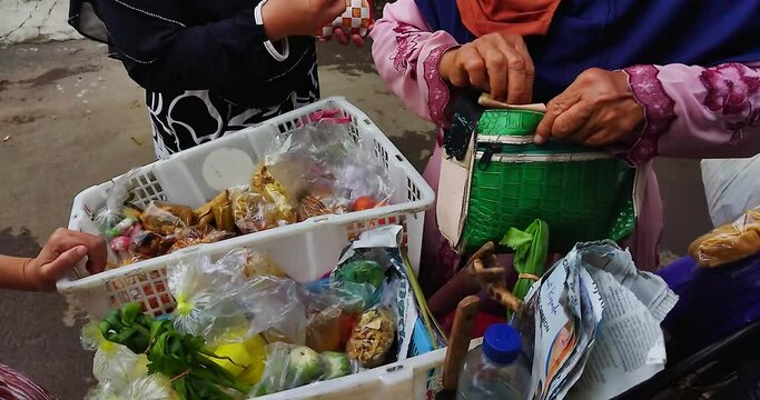 Transaction activities between sellers and buyers in front of a traditional market in Cirebon, West Java, Indonesia