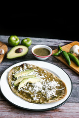 Memela sope quesadilla poblana of green sauce with cheese, onion and avocado traditional mexican food from Puebla, Mexico