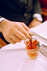 Armudu cups for the engagement ceremony . Boy holding armudu cup.