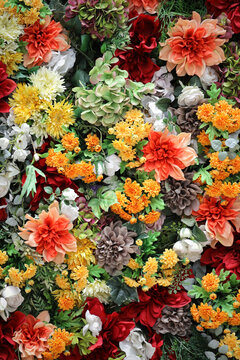 Photo for background material of colorful wall decorated with many artificial flowers