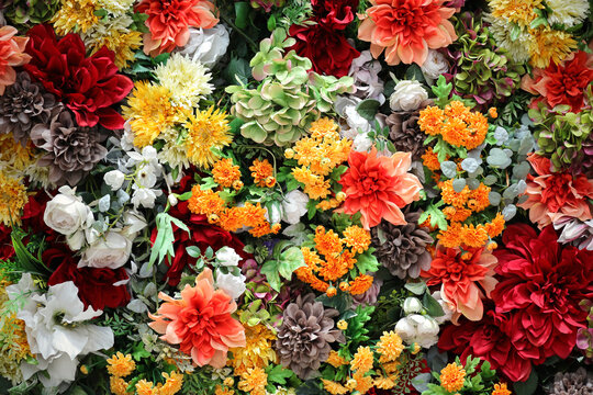 Photo for background material of colorful wall decorated with many artificial flowers