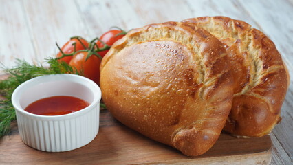 Latin American fried empanadas with tomato sauce. Argentinian Empanada is a pastry turnover filled with a variety of savory ingredients and baked or fried.