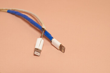 Two broken bare and rewound USB wires with duct tape