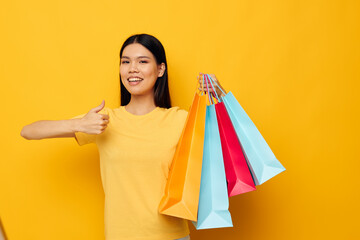 Charming young Asian woman fashion shopping posing isolated background unaltered