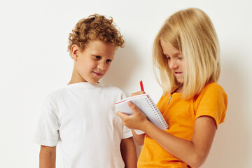 picture of positive boy and girl stand next to notepad pencil drawing emotions lifestyle unaltered