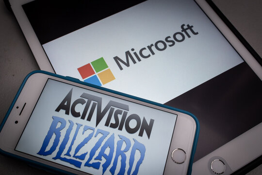 Kumamoto, JAPAN - Jan 24 2022 : Conceptual Microsoft and Activision Blizzard logos on smartphone and tablet in the dark mood. Microsoft announced that they are planning to purchase Activision-Blizzard
