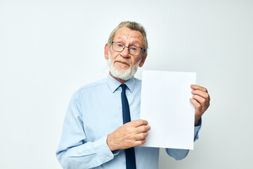 Photo of retired old man holding documents with a sheet of paper light background