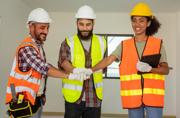Group of engineers, construction contractors and young black architects come together and trust the team to help complete the construction of the Housing site.Real estate development  and team concept