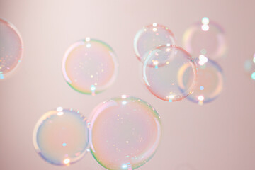 Beautiful Colorful Transparent Soap Bubbles Floating on Pink Background