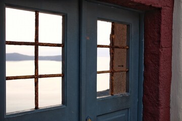 A window frame overlooking the aegean sea in Santorini Greece