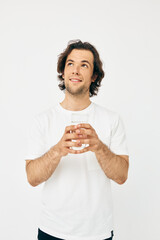 Cheerful man in a white T-shirt glass of water Lifestyle unaltered