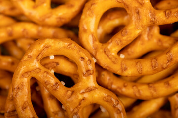 Crispy bread straws with salt, close-up, selective focus, top view.