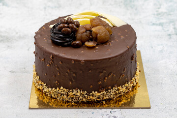 Celebratory cake on a gray background. Cake made with chestnuts and chocolate