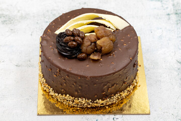 Celebratory cake on a gray background. Cake made with chestnuts and chocolate