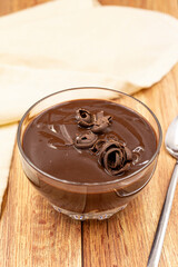 Supangle dessert on a wooden background. A chocolate pudding with a semi-solid, semi-liquid consistency.