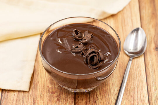 Supangle dessert on a wooden background. A chocolate pudding with a semi-solid, semi-liquid consistency.