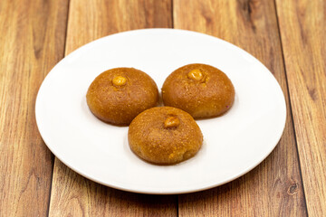 Traditional Turkish dessert sekerpare on a wooden background. Turkish dessert with syrup, ramadan and feast treat. Close up