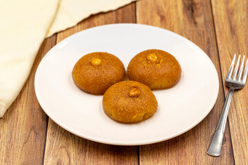 Traditional Turkish dessert sekerpare on a wooden background. Turkish dessert with syrup, ramadan and feast treat. Close up