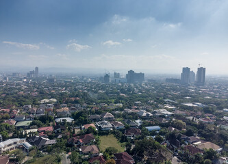 Fototapeta na wymiar Aerial shot of the Manila skyline skyscraper clusters as seen from Corinthian Gardens. 