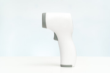 side view. contactless electronic thermometer on a white background. measuring device for measuring body temperature. home medicine cabinet. sale of medical products for home use.