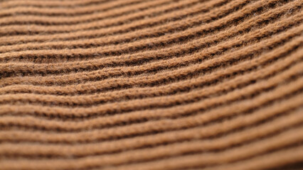 Textile abstract background. Clothing industry concept. Wavy clean material. Fibers of knitted clothes brown white threads. Knitted fabric threads macro