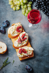red wine with snacks bruschetta with pears, cottage cheese, figs, thyme, nuts and honey, camembert cheese.