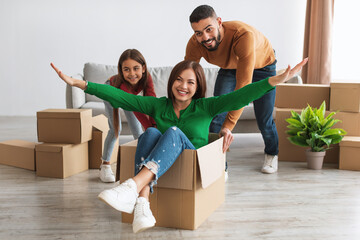 Happy family celebrating moving day in new apartment