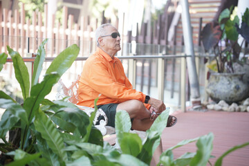 Naklejka na ściany i meble old elderly senior elder man relaxing on terrace.