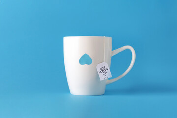 Blue monday tea. White cup on blue.