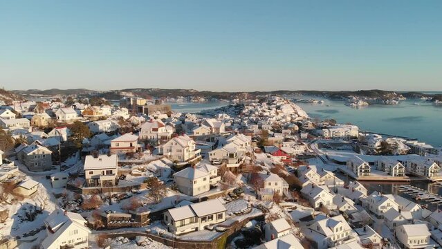 Cityscape Of Kragero Covered In Snow At Daytime In Norway - aerial drone shot