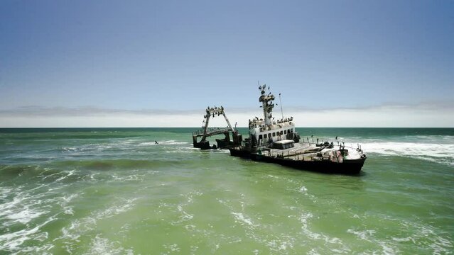 Drone flight towards rusted Zeila shipwreck on Skeleton Coast, Namibia