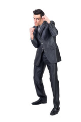 Obraz na płótnie Canvas Businessman in suit standing in fighting stance