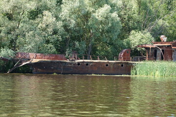 old abandoned rusty boat on the river