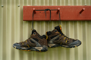 Soaking wet hiking boots hanging up outside a DoC hut, Nelson Lakes National Park, south island,...