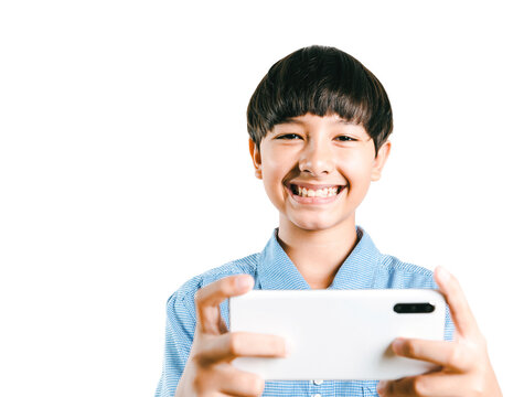 Cheerful Preteen Mix Race Boy Kid In A School Uniform Using A Smartphone For Online Learning, Social Media, App Texting, Or Playing An Online Game On White Background. Child Technology Study Concept