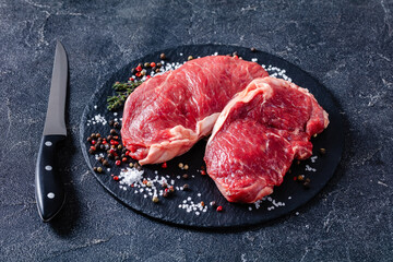 striploin steaks on a black stone plate