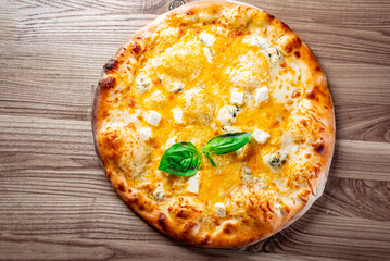 Quattro Formaggio (Four Cheese) Pizza. Italian pizza on wooden table background