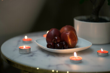 white round table with a plate of apples