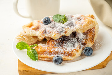 Fresh croffles on a light background. Mix of waffles and croissant.