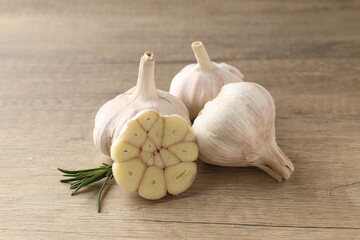 Bulbs of garlic on wooden background, close up