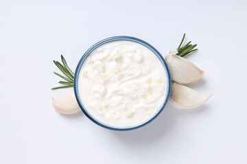 Garlic sauce and ingredients on white background