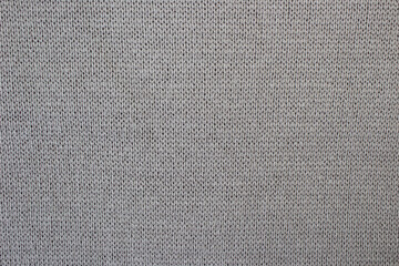 Knitted gray-brown knitted fabric. Machine knitting