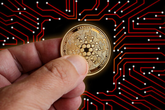 Golden glow digital cardano on isolated computer printed circuit board. For cryptocurrency market exchange promotion, news, token sales, and blockchain fund use.