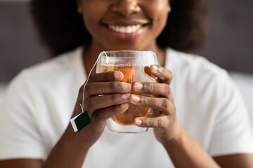 Female hands holding mug with hot drink, cropped