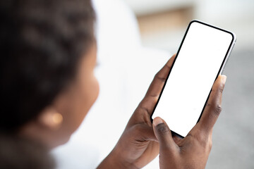 Unrecognizable black woman using smartphone with empty screen